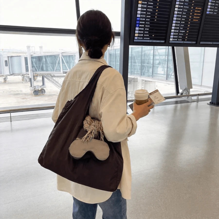 Mahogany Foldaway Keychain Tote carried at an airport