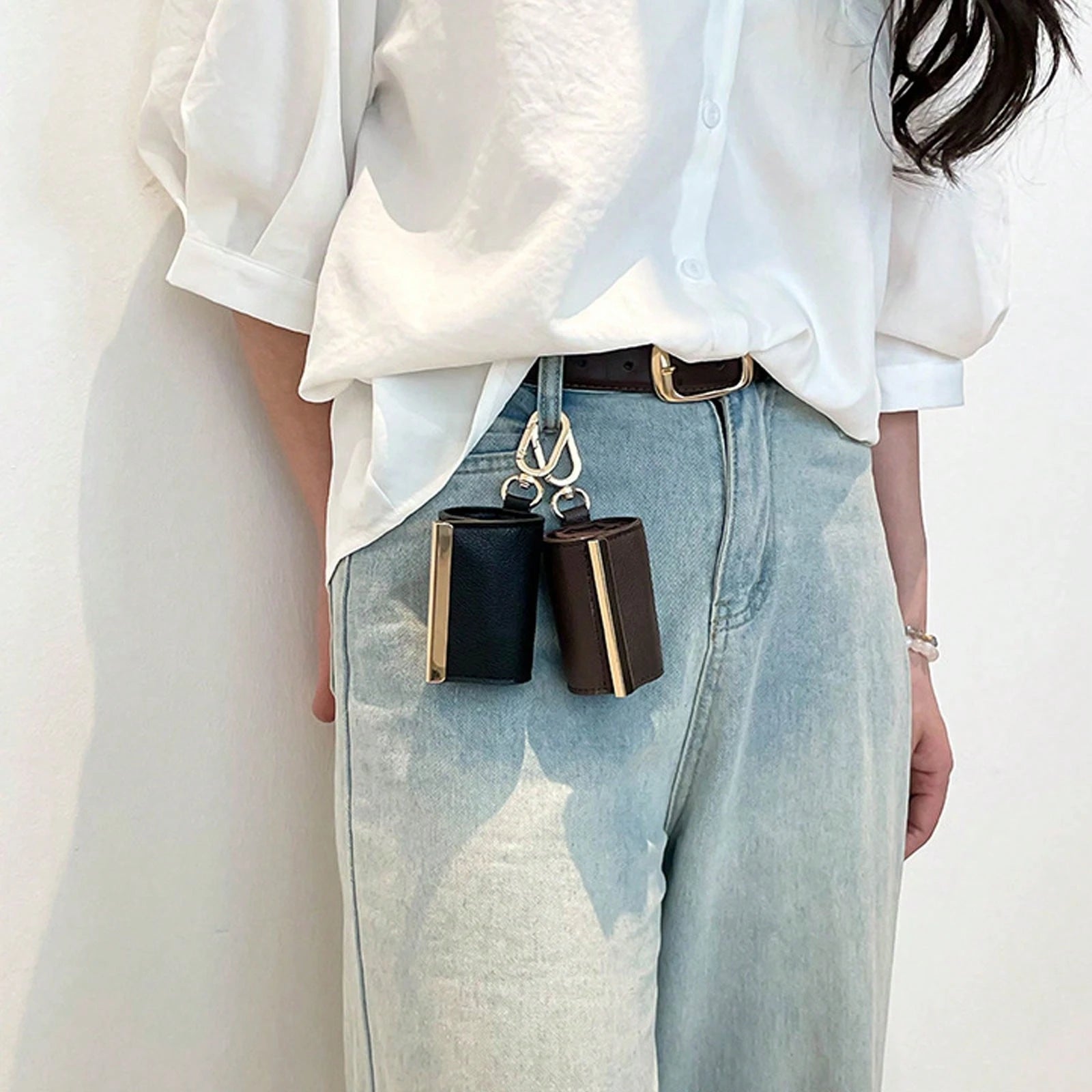 Foldaway Keychain Tote pouches clipped to a waistband